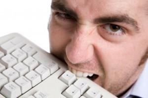 frustrated, man bites keyboard