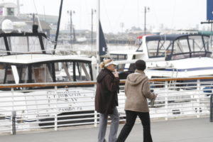 ali & joie walk along harbor 